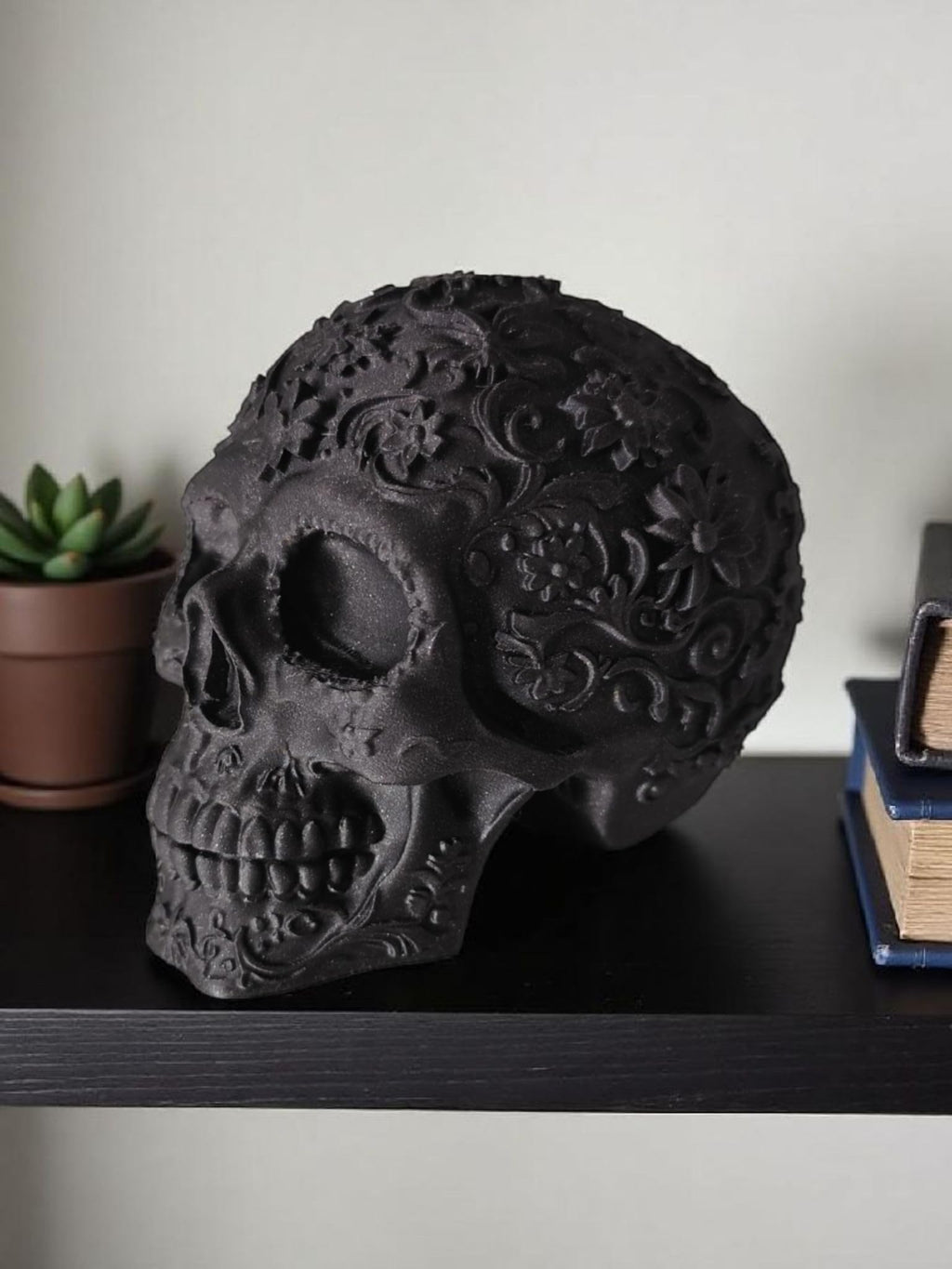 Glossy Black Decorative Skull Statue – Floral Engraved Gothic Skeleton