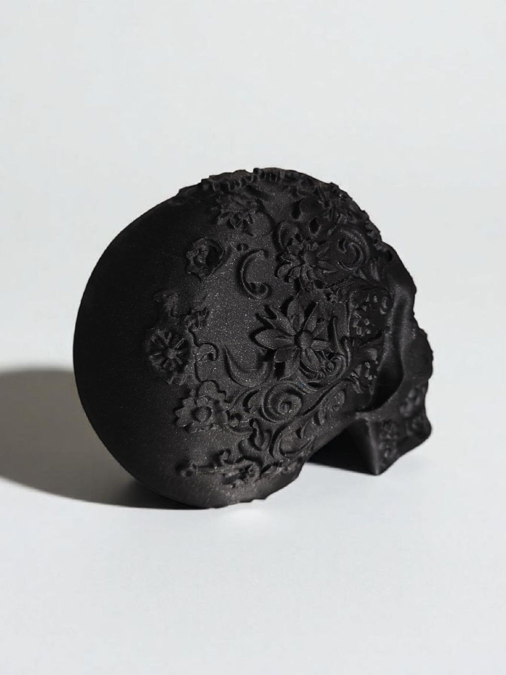 Glossy Black Decorative Skull Statue – Floral Engraved Gothic Skeleton