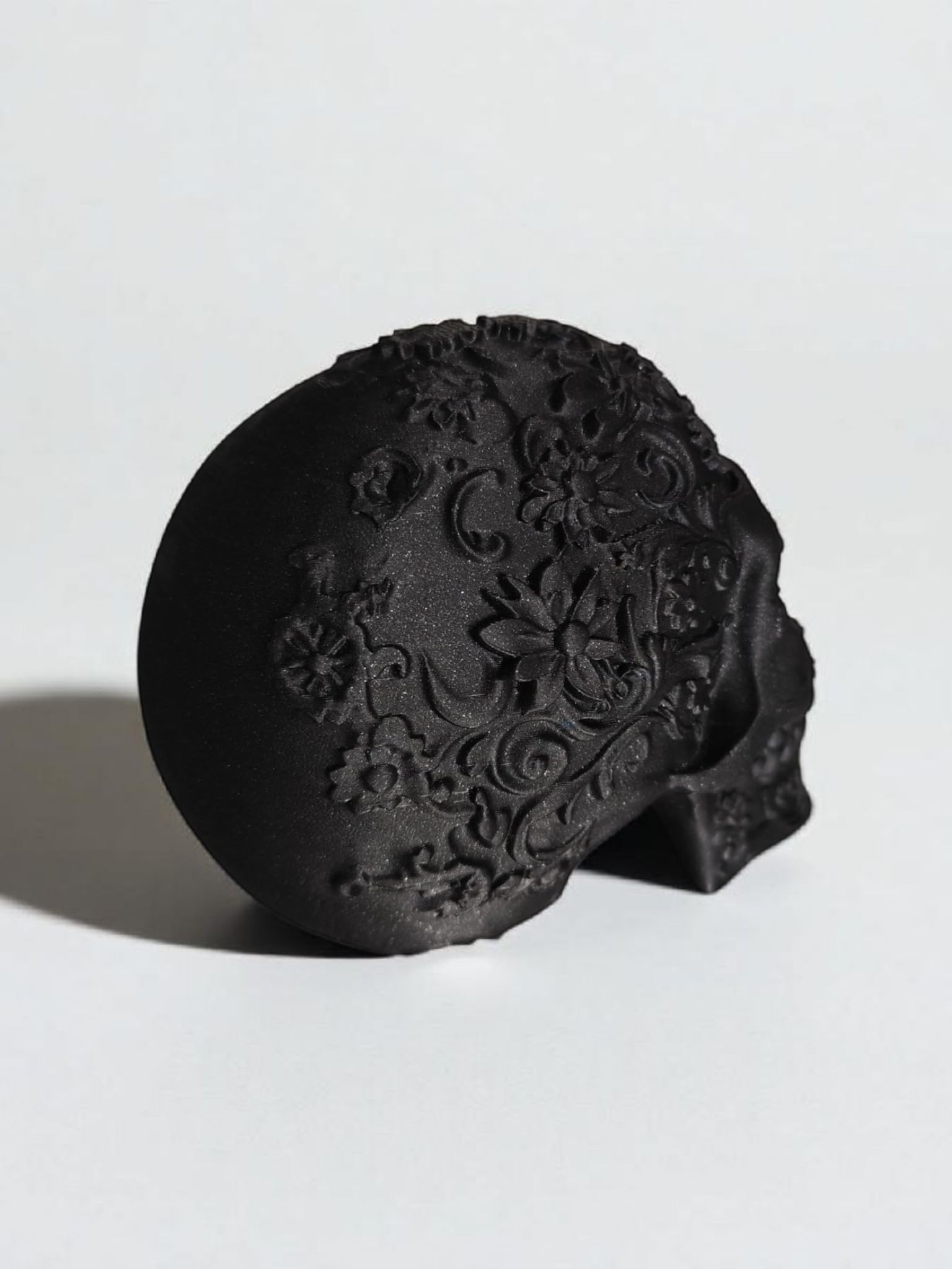 Glossy Black Decorative Skull Statue – Floral Engraved Gothic Skeleton